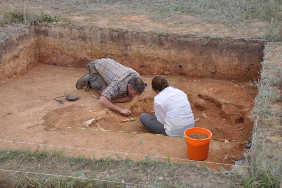 Alex and Alice digging a pit